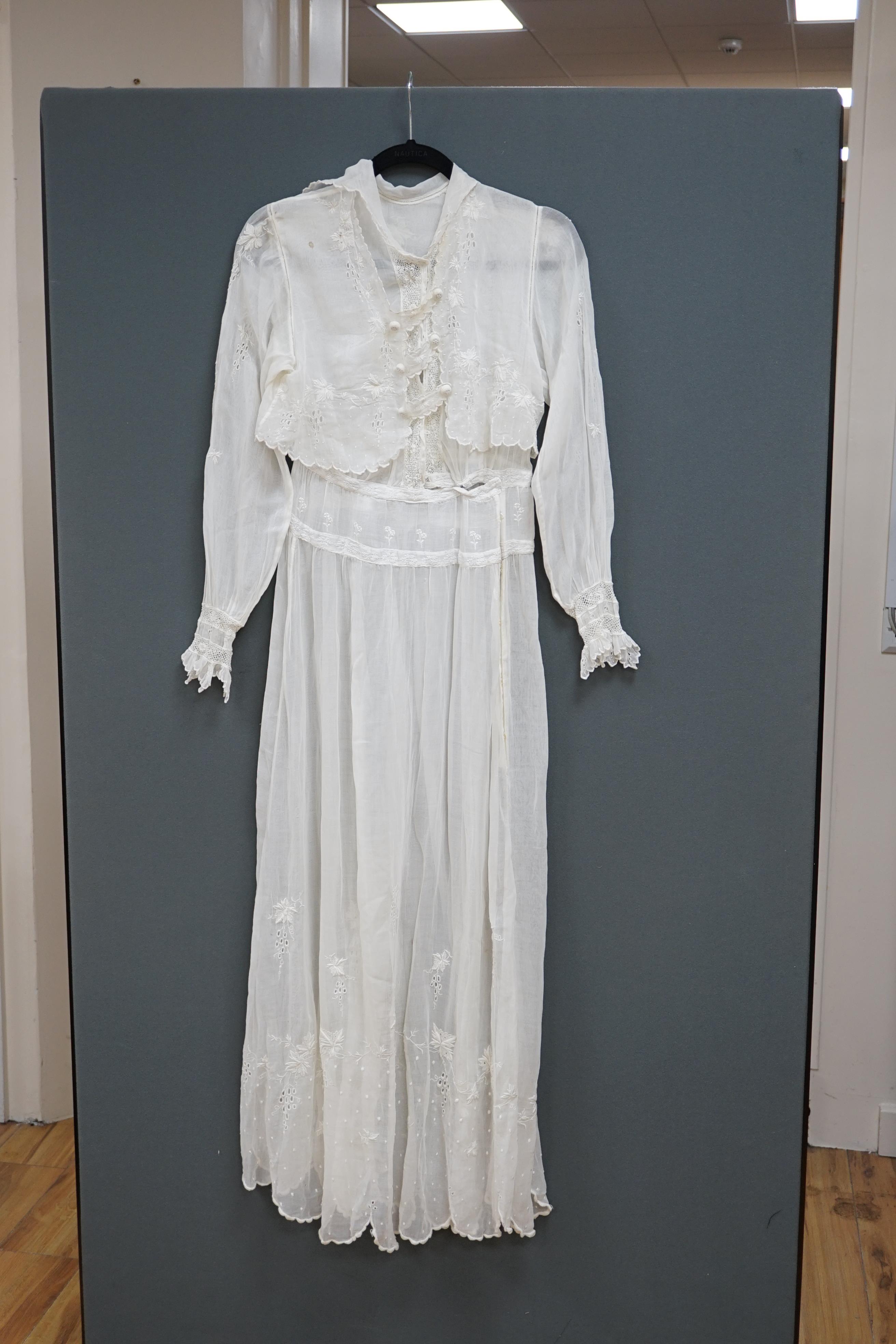 An early Edwardian fine lawn ladies hand made and embroidered crochet dress, embroidered with a white worked skirt, cuffs and lower waist and Irish crochet bodice insertions, with novelty detailing of a faux jacket front